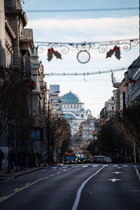 City street and buildings against sky