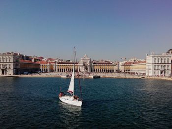 Boats in canal with buildings in background