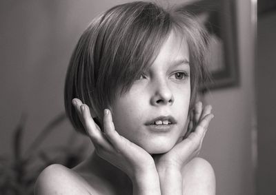 Close-up of boy looking away at home