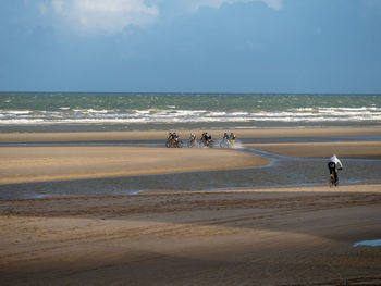 Bike riding at he beach in winter-times