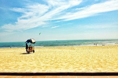 Man on beach against sky