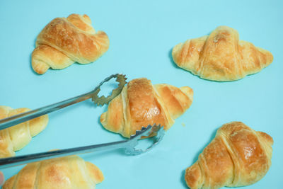 High angle view of bread on table against blue background