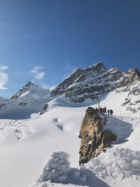 Scenic view of snow covered mountains against sky