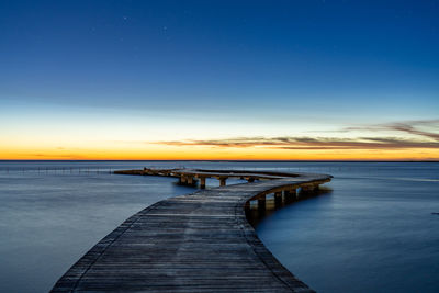 Scenic view of bridge at sunset