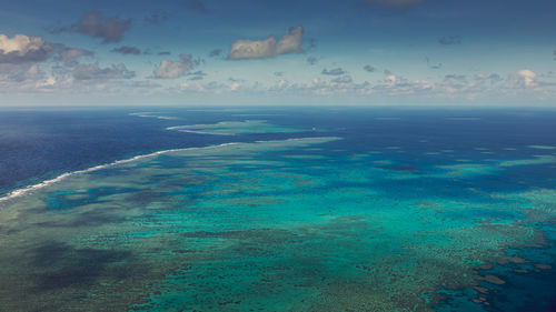 Aerial view of sea against blue sky