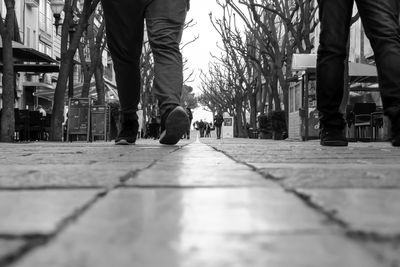Low section of man and woman walking on street