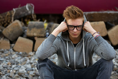 Portrait of young man sitting outdoors