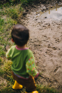 Rear view of boy on field