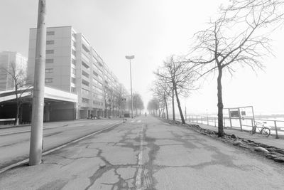 Empty road leading towards building