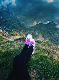 Low section of person standing on grassy field