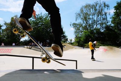 Low section of man skateboarding on sports ramp