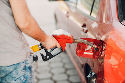 Midsection of man repairing car