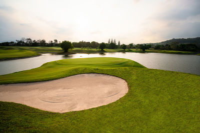 Scenic view of golf course against sky