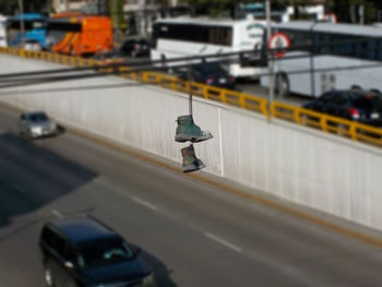 High angle view of shoes hanging on cable over street in city