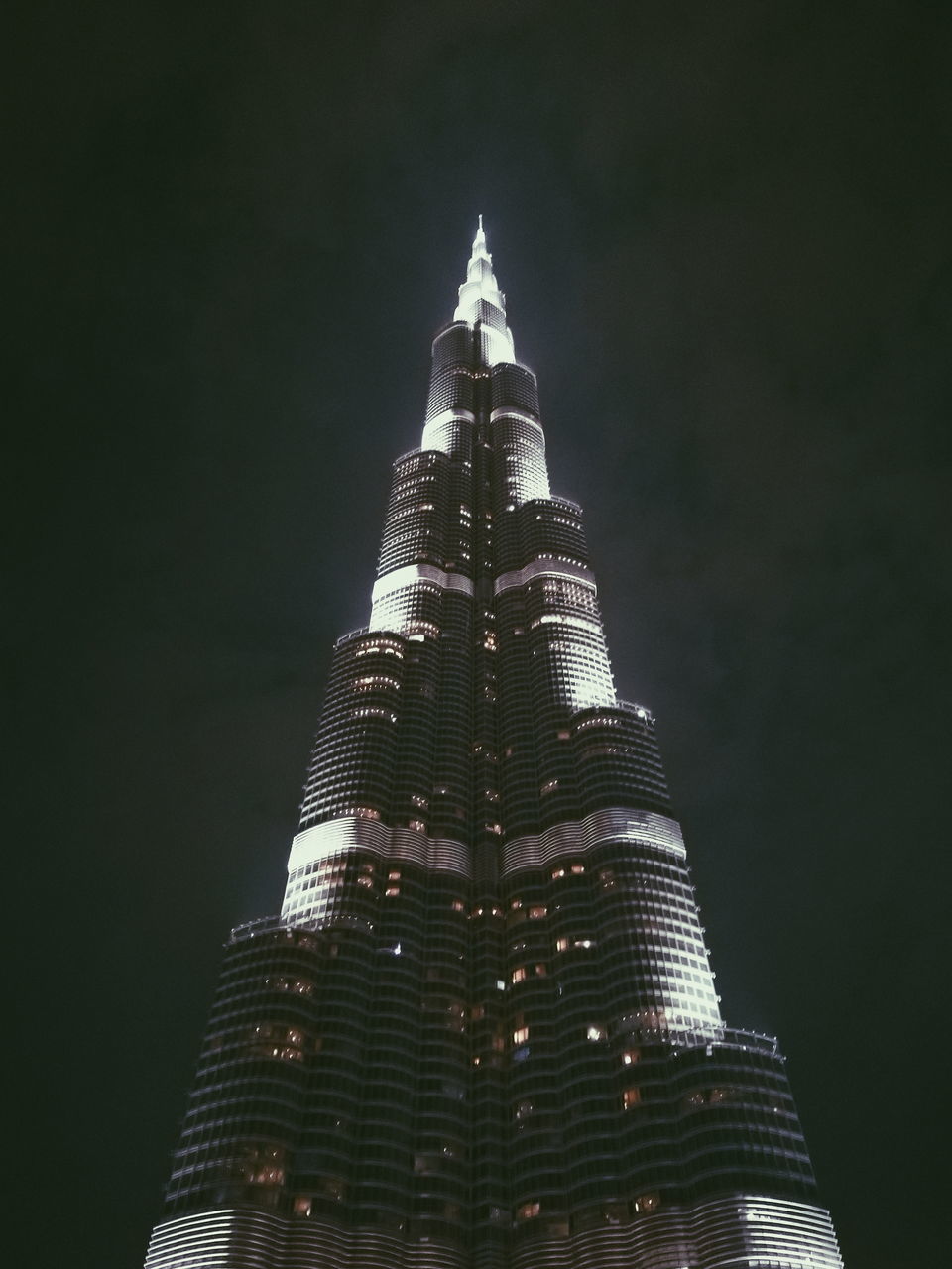 building exterior, built structure, architecture, tall - high, building, low angle view, office building exterior, skyscraper, tower, night, no people, travel destinations, sky, illuminated, city, nature, tourism, modern, travel, outdoors, spire, financial district, place of worship