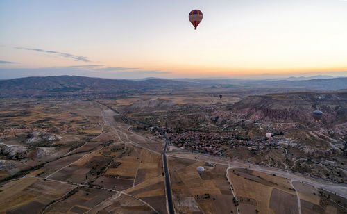 High angle view of hot air balloon flying over landscape