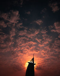 Low angle view of silhouette building against sky during sunset