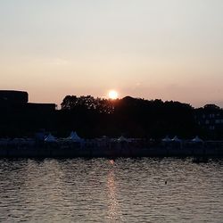 Scenic view of river at sunset