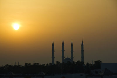 Silhouette of building against sky during sunset