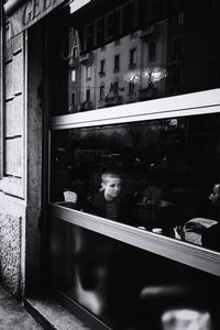 Woman looking through window