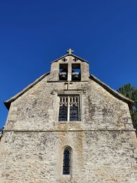 Low angle view of building against clear blue sky