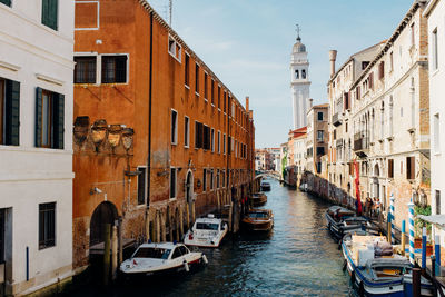 Boats in canal with buildings in background
