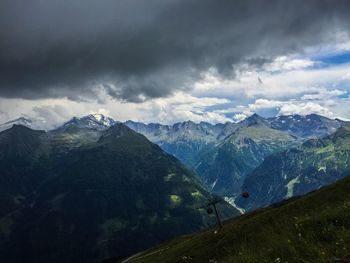 Scenic view of mountains against cloudy sky