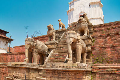 Statue of historic building against sky