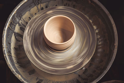 Raw clay pot on a potter's wheel. top view