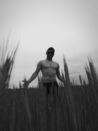 Man standing on field against clear sky