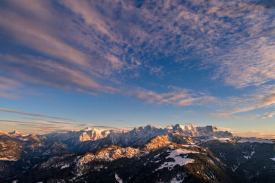 Scenic view of snowcapped mountains against sky during sunset