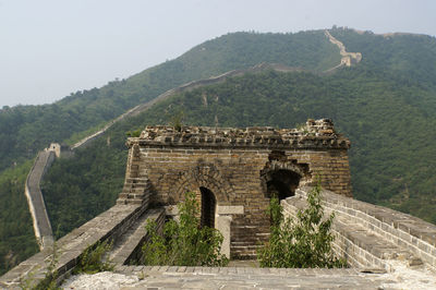 Built structure on mountain against sky