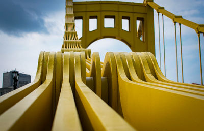 Low angle view of yellow bridge against sky