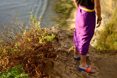 Low section of woman walking on street