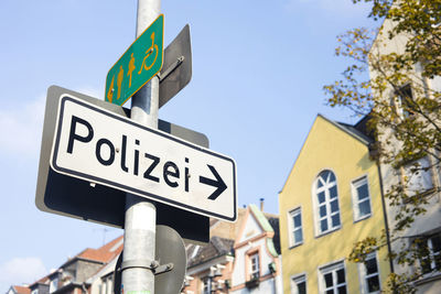 Low angle view of road sign against sky