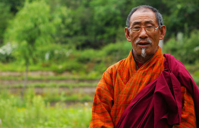 Portrait of man standing on field