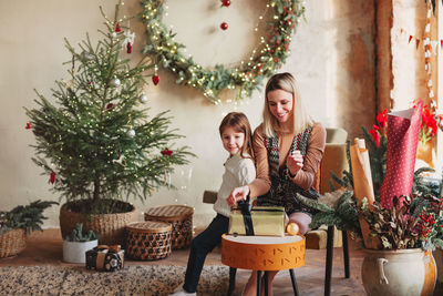 Mother and girl on christmas tree