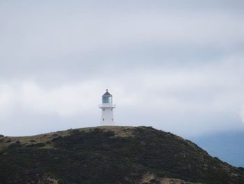 Lighthouse against foggy sky