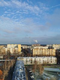 High angle view of road by buildings against sky