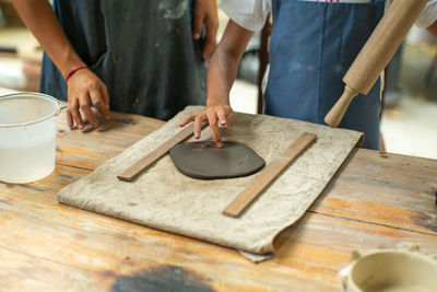 Midsection of woman preparing food on table