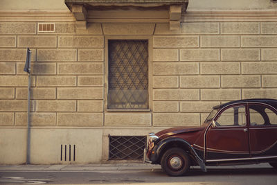 Car parked on street against wall