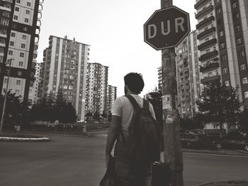 Rear view of man standing on city street