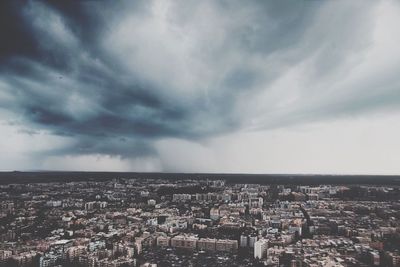 Cityscape against cloudy sky