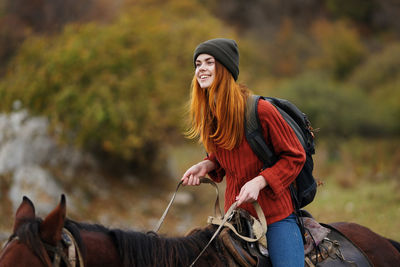 Young woman riding horse