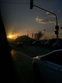 Traffic on road at sunset