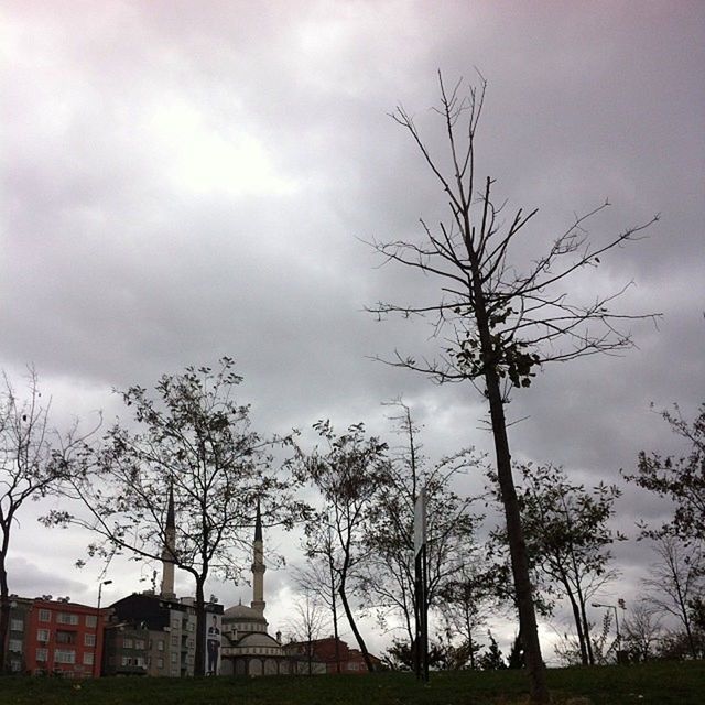 sky, bare tree, tree, cloud - sky, building exterior, cloudy, built structure, architecture, branch, cloud, field, overcast, grass, nature, low angle view, house, landscape, tranquility, day, outdoors