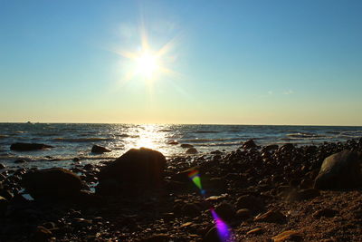 Scenic view of sea against clear sky at sunset