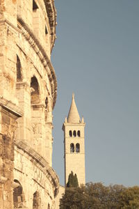 Low angle view of bell tower against sky