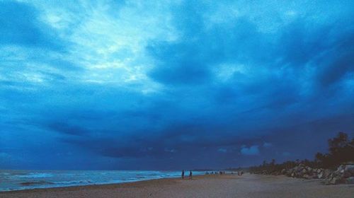 Scenic view of sea against cloudy sky