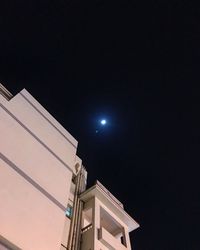 Low angle view of illuminated building against sky at night